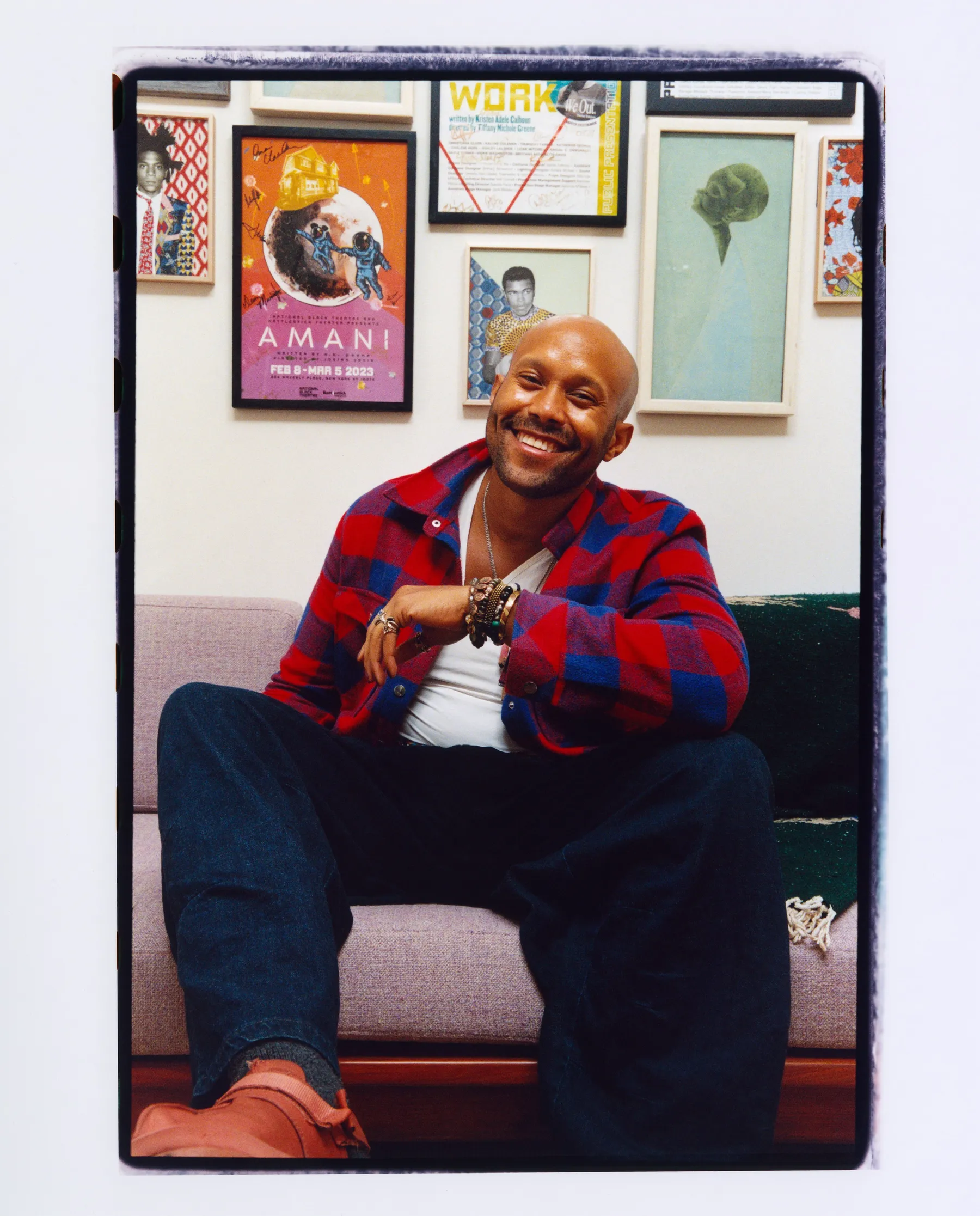 image of person sitting on couch in front of framed art work